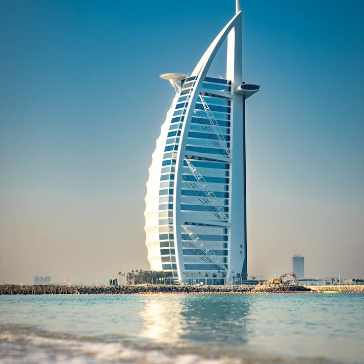 Iconic sail-shaped skyscraper by the beach, representing modern architecture in Dubai.